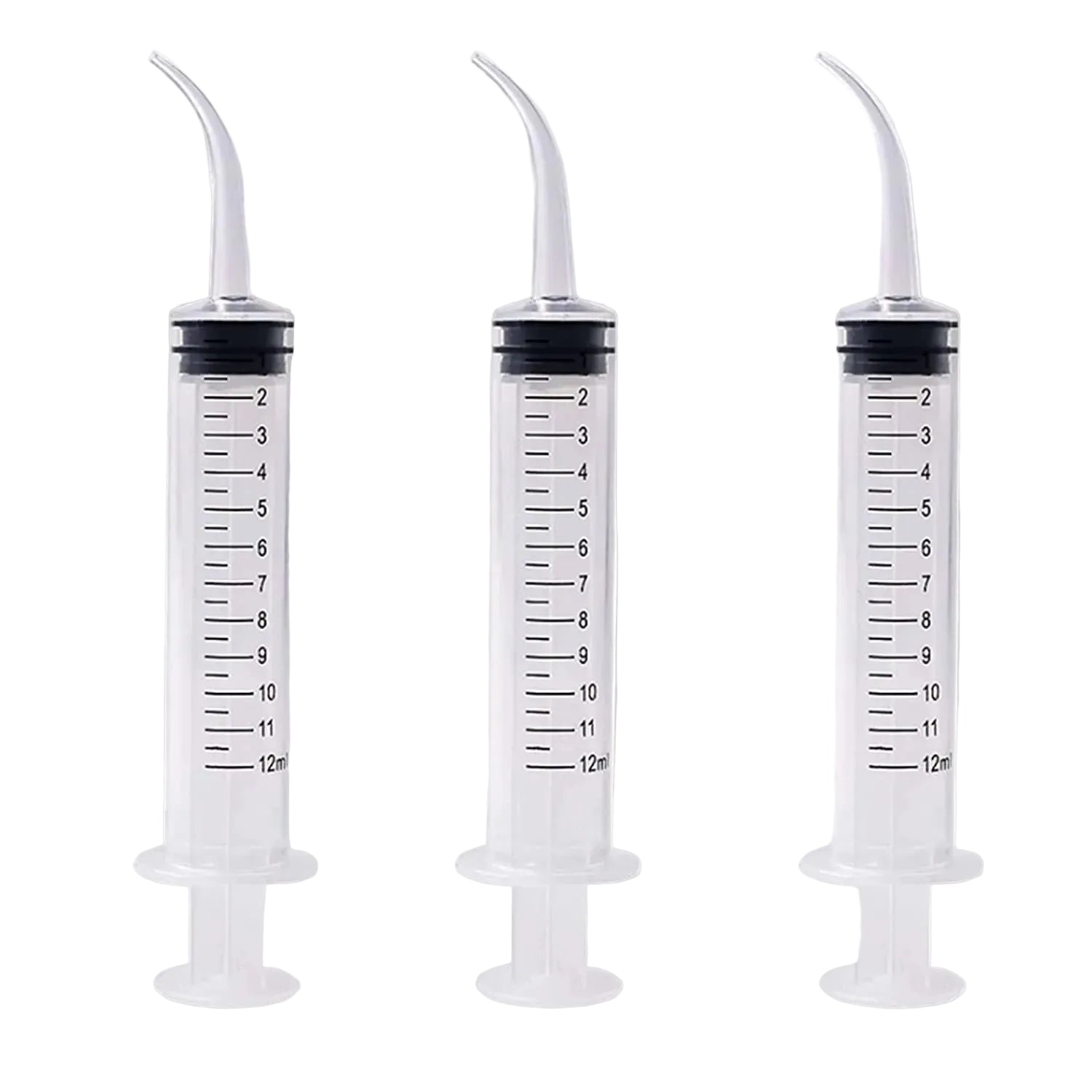 Three plastic syringes with measurement markings on a gray background